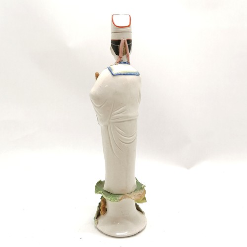 27 - Oriental pottery figure standing on a lotus leaf 33cm high A/F