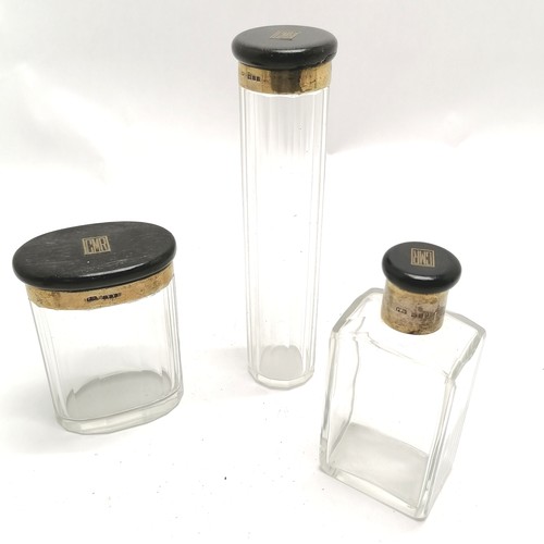 156 - Set of 3 dressing table jars with ebony and silver gilt lids tallest 18.5cm high and has a split to ... 