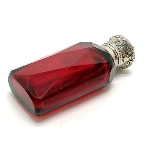 161 - Antique unmarked silver topped ruby glass scent bottle with glass stopper 8cm high - has small dints... 