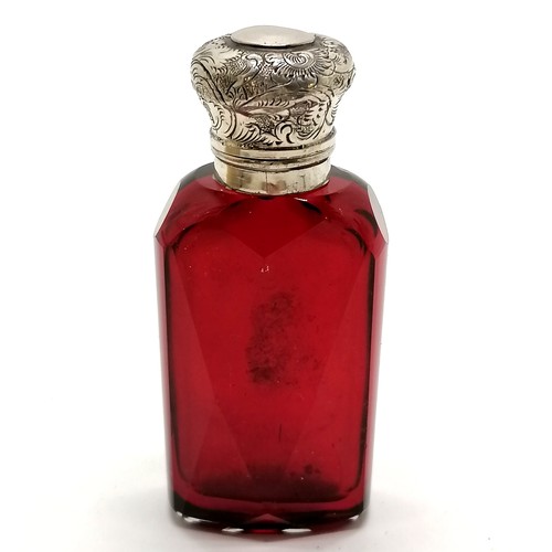 161 - Antique unmarked silver topped ruby glass scent bottle with glass stopper 8cm high - has small dints... 