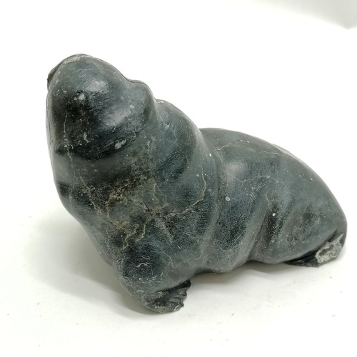 164 - 2 Inuit stone carvings of a seal and a walrus both 13cm long with signature and numbers to the bases