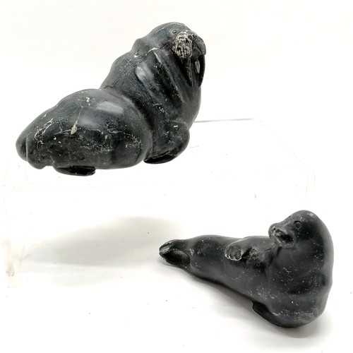 164 - 2 Inuit stone carvings of a seal and a walrus both 13cm long with signature and numbers to the bases