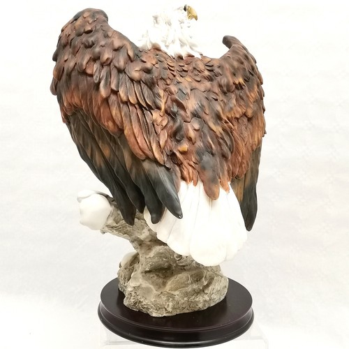 216 - La Anina collection figurine of a bald eagle perched on a rock mounted on a wooden stand - 45.5cm to... 