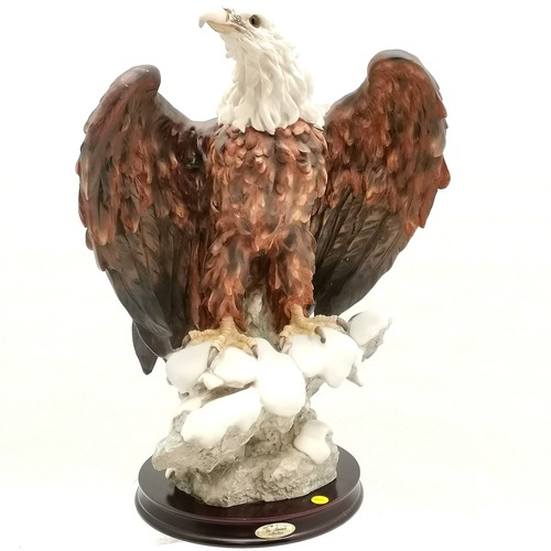 216 - La Anina collection figurine of a bald eagle perched on a rock mounted on a wooden stand - 45.5cm to... 