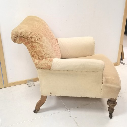 281 - Edwardian oak framed upholstered easy chair on turned legs ending in castors,  82 cm in height, 78 c... 