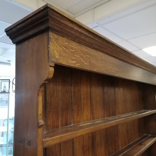 306 - An Antique oak dresser with three tier delft rack, the base having 6 short drawers and 2 cupboards, ... 