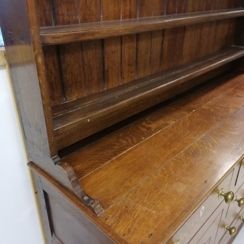 306 - An Antique oak dresser with three tier delft rack, the base having 6 short drawers and 2 cupboards, ... 