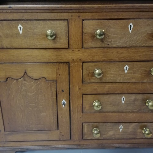 306 - An Antique oak dresser with three tier delft rack, the base having 6 short drawers and 2 cupboards, ... 