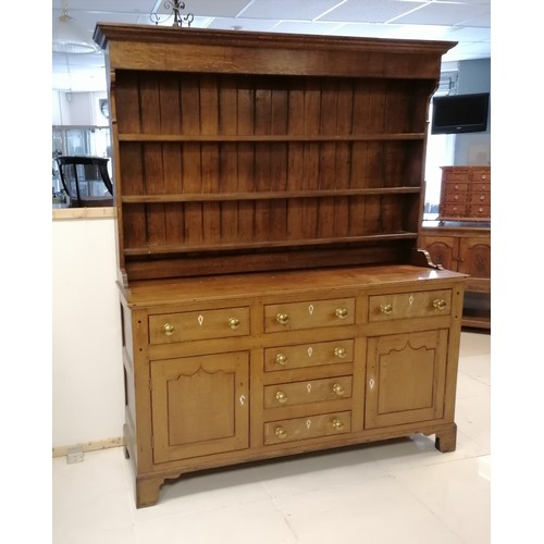 306 - An Antique oak dresser with three tier delft rack, the base having 6 short drawers and 2 cupboards, ... 