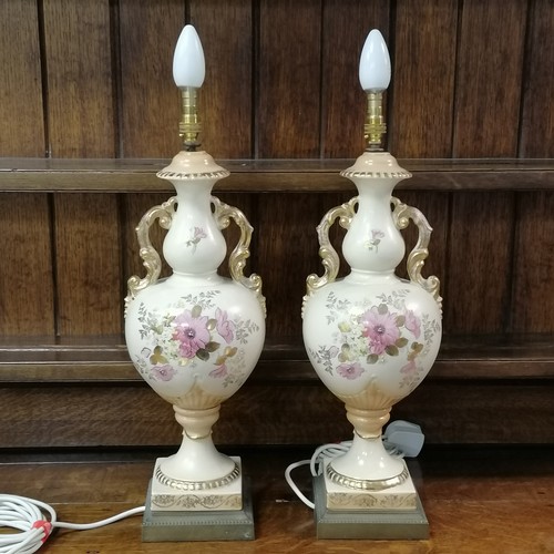 308 - Pair of ceramic vase lamps, decorated with flowers on blush ivory background and gilded decoration o... 