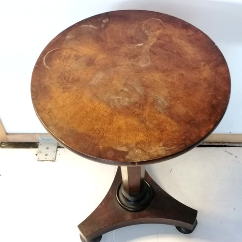 310 - An Antique walnut pedestal, circular top occasional table on bun feet fitted with castors, the top h... 