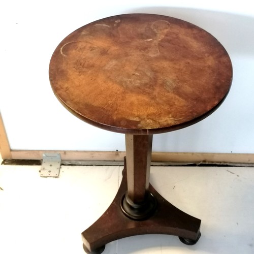 310 - An Antique walnut pedestal, circular top occasional table on bun feet fitted with castors, the top h... 