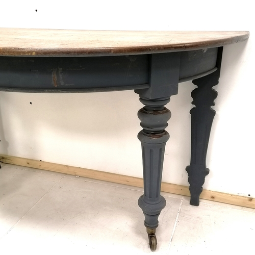 370 - Antique oak blue painted demi lune table with brass castors 31cm wide x 63cm deep x 73cm high & in g... 