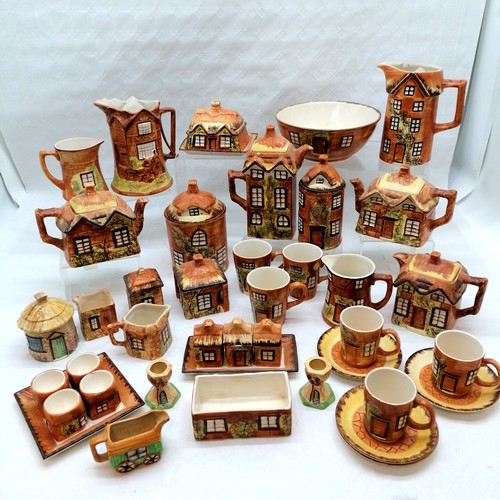 405 - Large collection of Cottage ware china to include Teapots, coffee pots, storage containers, jam pots... 