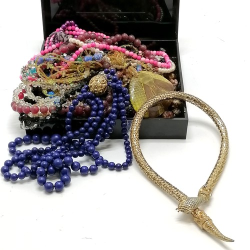 588 - Quantity of costume necklaces in a black box including a snake gilt metal necklace