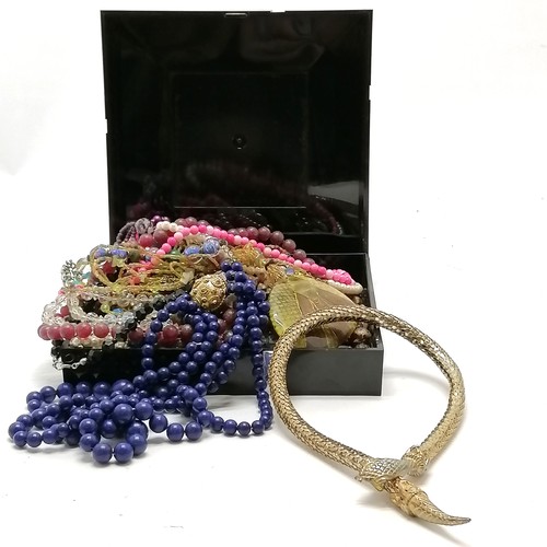 588 - Quantity of costume necklaces in a black box including a snake gilt metal necklace