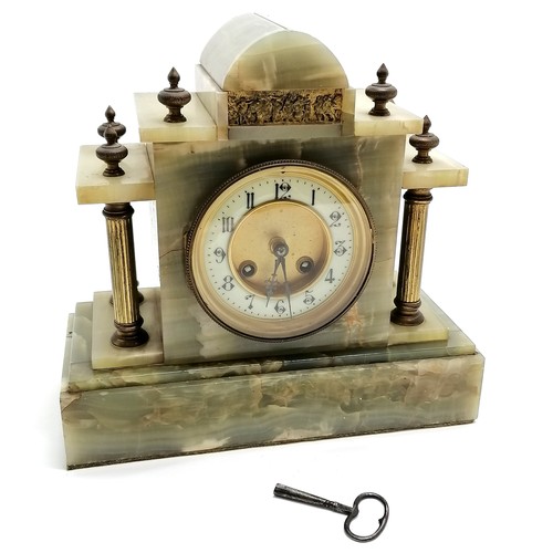 940 - Antique onyx and gilt metal mounted continental mantle clock with key. 28cm x 26.5cm high. Running