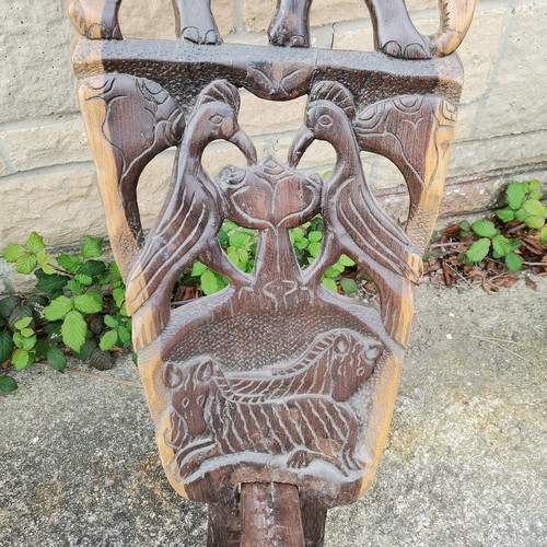 20 - Carved African high back chair decorated with assorted animals 90 cm high x 21 cm seat t/w similar 9... 