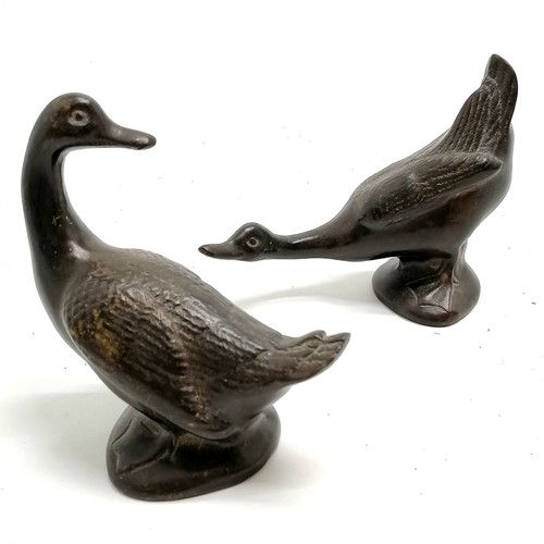 27 - Pair of bronze ducks tallest 12cm high T/W an Eastern brass pot with unusual twist design 10cm high