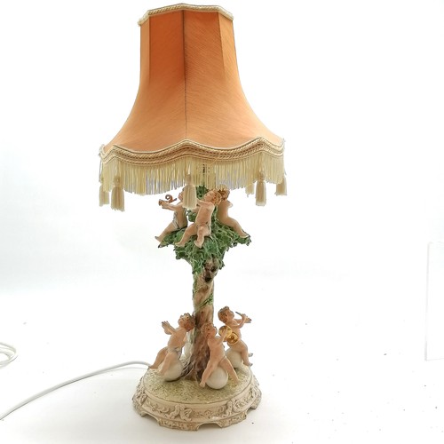 81 - Capodimonte lamp base decorated with putti playing musical instruments, base 41cm high + shade - som... 