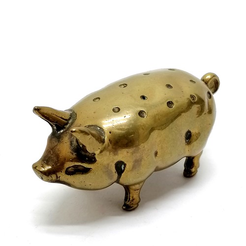 99 - Antique brass pig hat pin stand 5cm long x 3cm high- in good used condition.