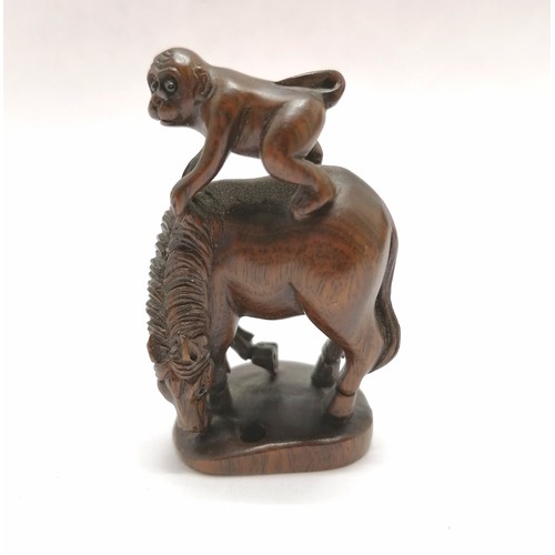 101 - Carved wooden figure of a monkey on a horse as an oriental toggle with bead eyes 5cm high