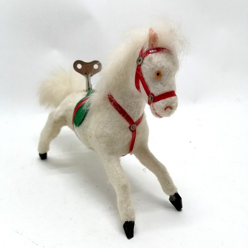 104 - Vintage white felt wind up horse with fur mane and tail 21cm long x 15cm high- in good condition and... 