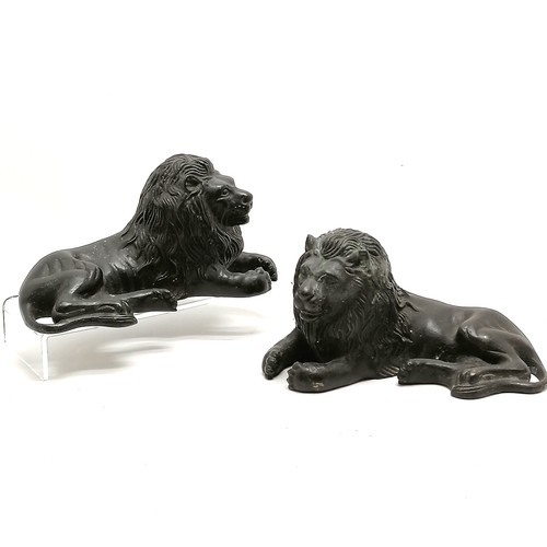 113 - Pair of cast bronze reclining lion figures 19cm long x 10cm high