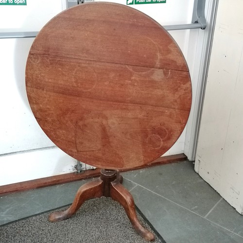 131 - Antique mahogany tip top occasional table on turned centre column terminating on tripod base, split ... 