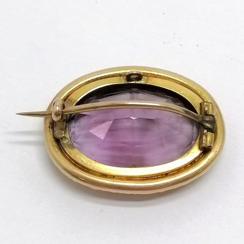 505 - Antique unmarked 15ct gold brooch set with amethyst in original G & T Davison (Newcastle on Tyne) bo... 