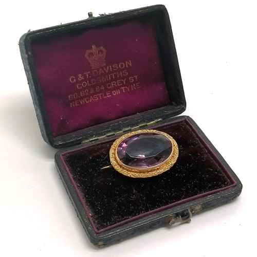 505 - Antique unmarked 15ct gold brooch set with amethyst in original G & T Davison (Newcastle on Tyne) bo... 