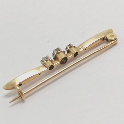 516 - Antique indistinctly marked (18ct) gold bar brooch set with 3 diamonds - 4cm & 2.4g total weight
