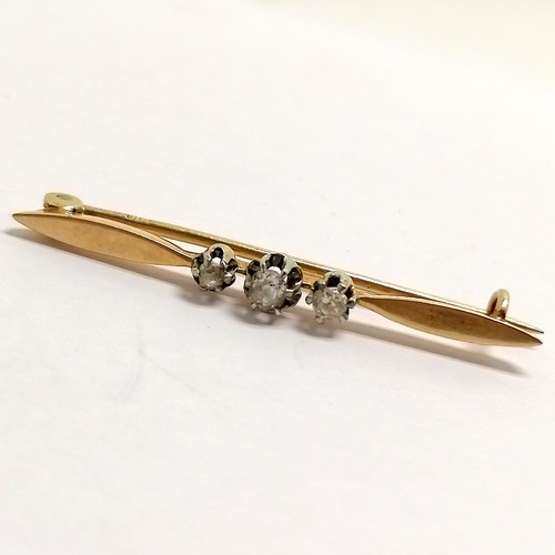 516 - Antique indistinctly marked (18ct) gold bar brooch set with 3 diamonds - 4cm & 2.4g total weight