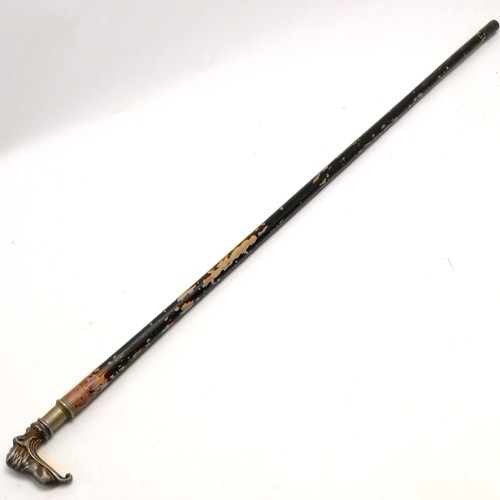 24 - Antique ebonised walking cane with bronze handle depicting a recumbent lion 84cm long- losses to the... 