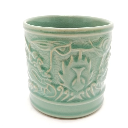 56 - Oriental crackle green glaze cylindrical pot with dragon detail - 11.5cm diameter x 11.5cm high with... 