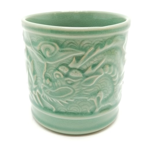 56 - Oriental crackle green glaze cylindrical pot with dragon detail - 11.5cm diameter x 11.5cm high with... 