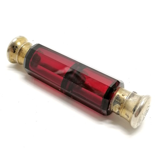 58 - Antique ruby glass double ended scent bottle with unmarked silver gilt lids 12cm long - small dents ... 