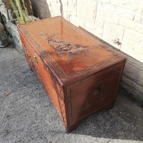 50 - Oriental carved Camphorwood blanket box, with carved village scenes within greek key pattern border,... 