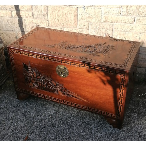 50 - Oriental carved Camphorwood blanket box, with carved village scenes within greek key pattern border,... 