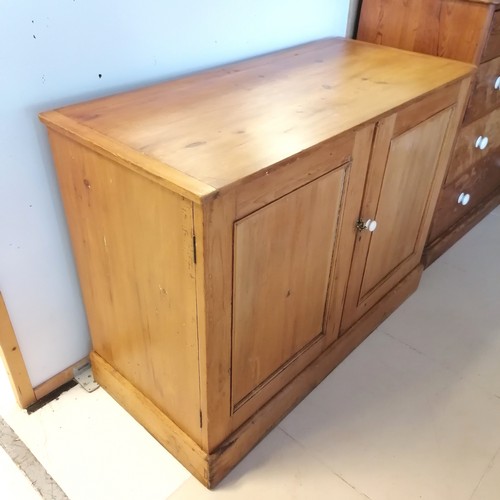 260 - Antique pine 2 door Cupboard, with panelled doors, revealing fitted shelf, on platform base. 122 cm ... 