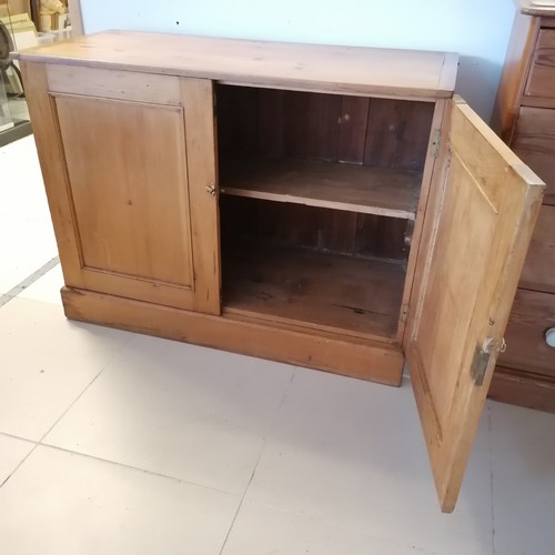 260 - Antique pine 2 door Cupboard, with panelled doors, revealing fitted shelf, on platform base. 122 cm ... 