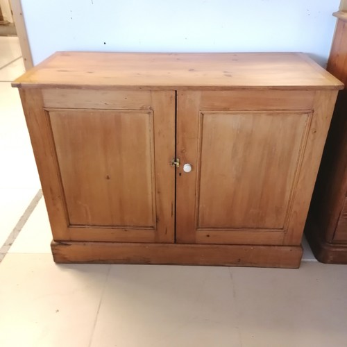 260 - Antique pine 2 door Cupboard, with panelled doors, revealing fitted shelf, on platform base. 122 cm ... 