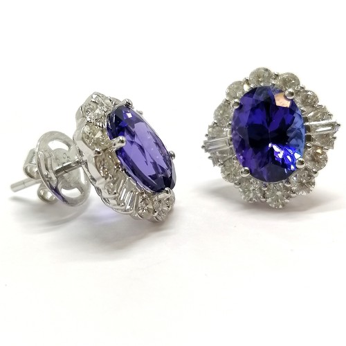 679 - Unmarked (touch tests as 18ct white gold) tanzanite & diamond cluster pair of earrings - total weigh... 