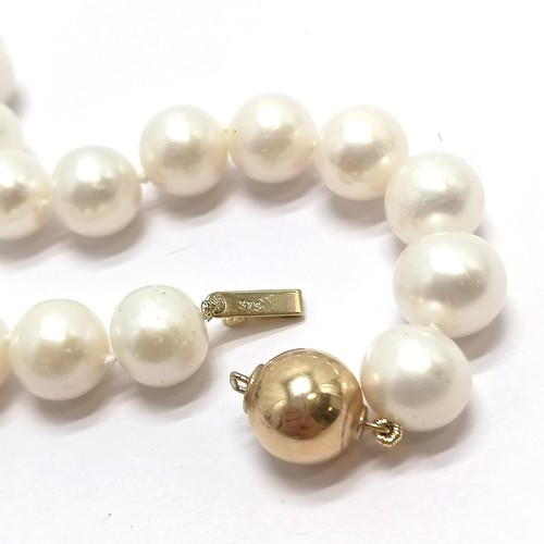 680 - String of cultured pearls (43cm long & pearls approx 10mm diameter) with a 9ct marked gold ball clas... 