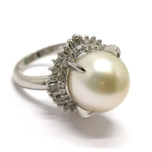 681 - Platinum marked ring set with a pearl surrounded by 2 halos of diamonds - size L½ & 9.4g total weigh... 