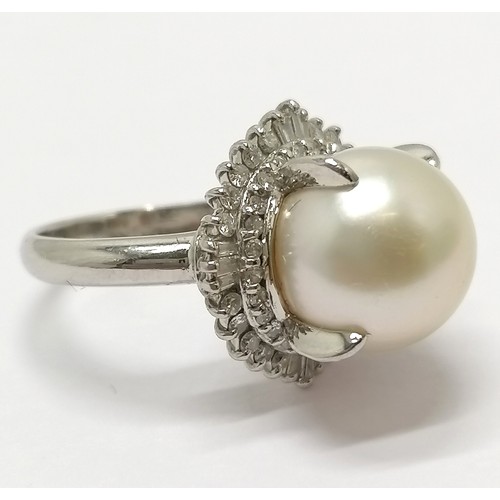 681 - Platinum marked ring set with a pearl surrounded by 2 halos of diamonds - size L½ & 9.4g total weigh... 