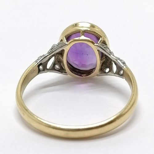 683 - Unmarked (touch tests as 18ct) white & yellow gold amethyst ring with diamond set shoulders - size P... 