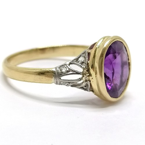 683 - Unmarked (touch tests as 18ct) white & yellow gold amethyst ring with diamond set shoulders - size P... 