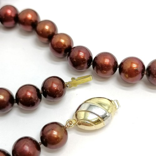 684 - Strand of chocolate coloured pearls with a 9ct marked gold clasp - 44cm long