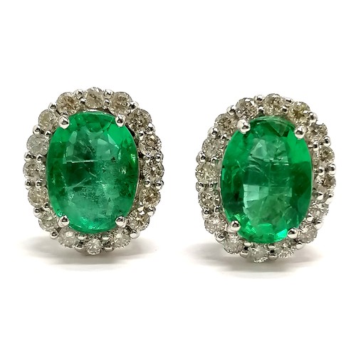 761 - 18ct marked white gold emerald & diamond cluster earrings - 4.3g total weight (emeralds approx 8.8mm... 